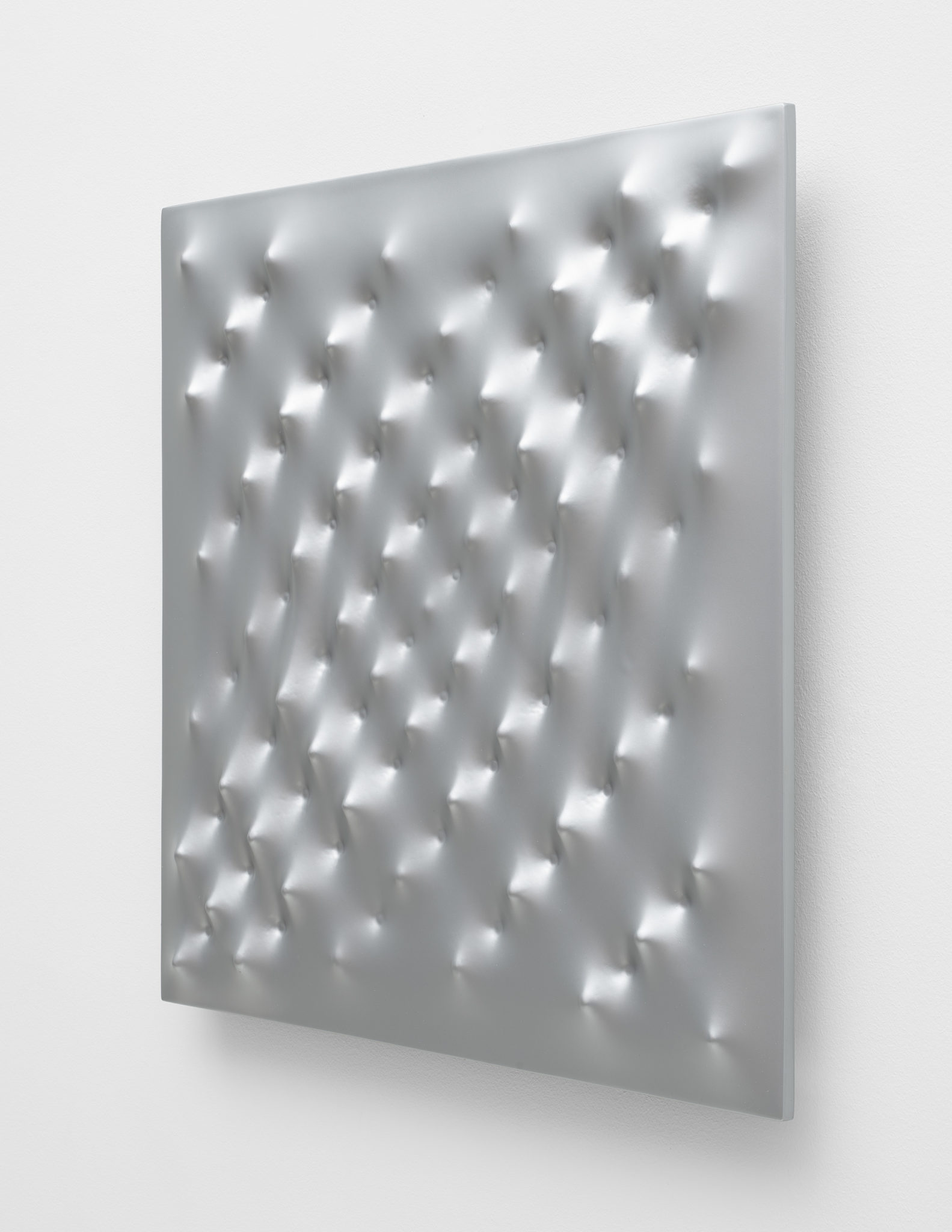 Side view of Enrico Castellani's aluminum work Superficie argento, 2006