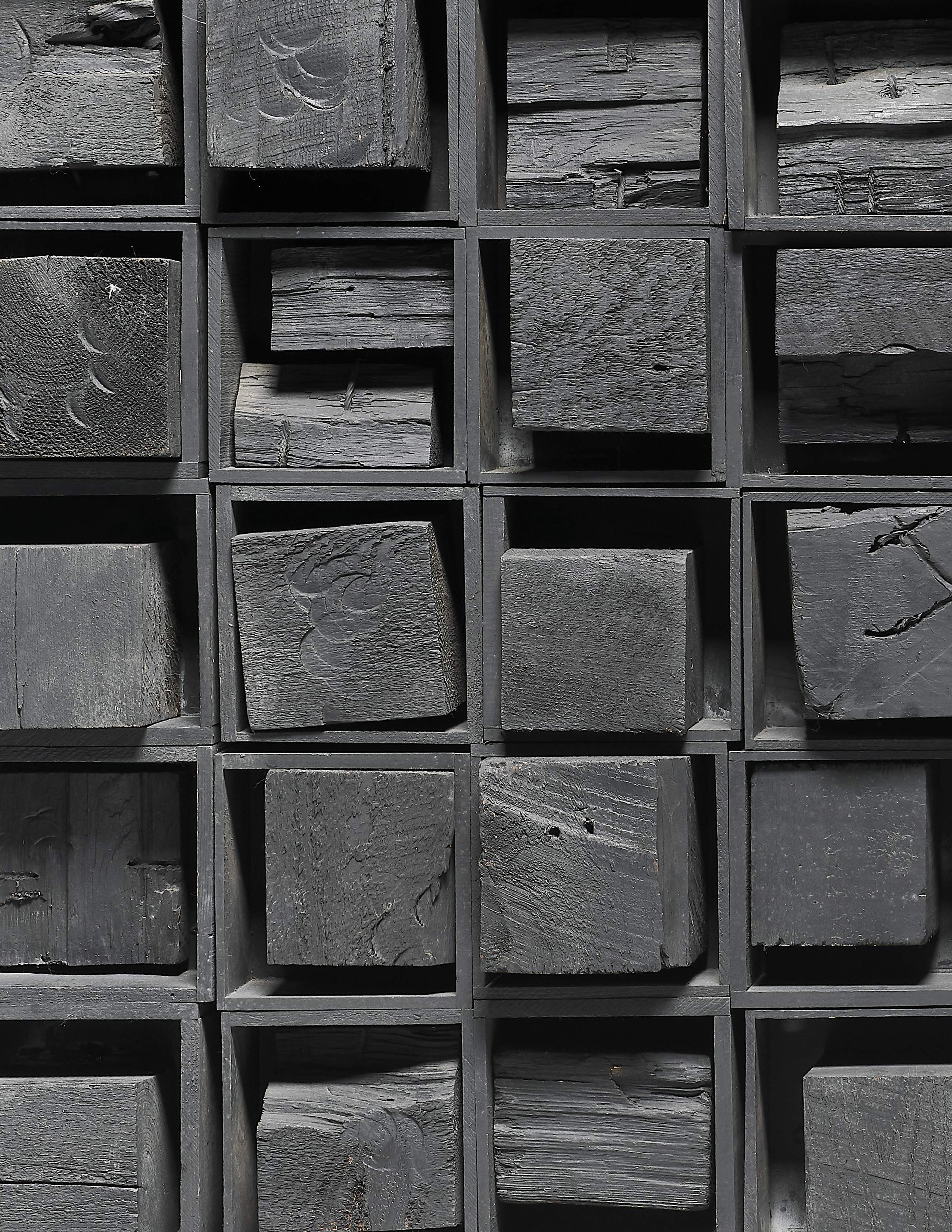 Detail view of Louise Nevelson's black painted wood sculpture Ancient Secrets II