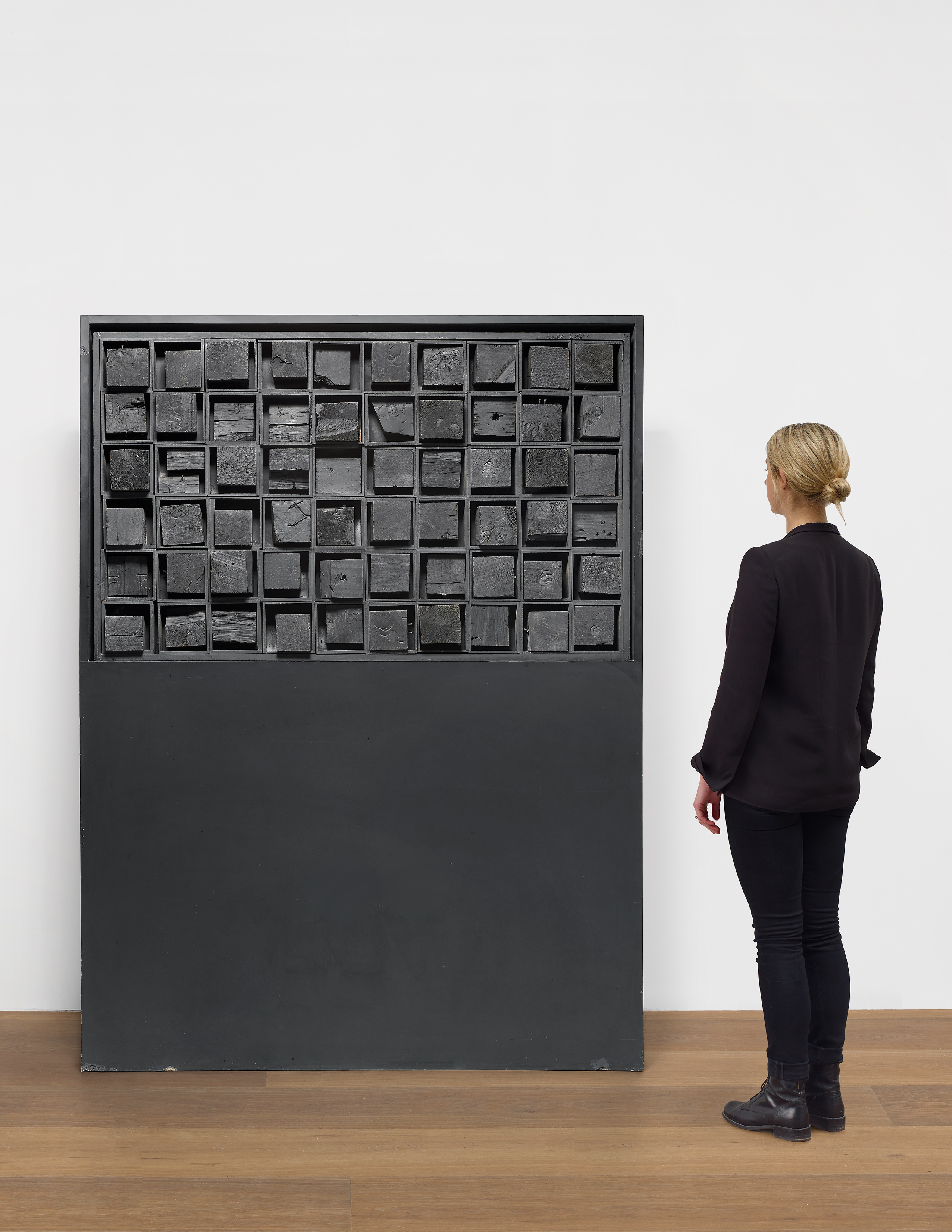 Scale view of Louise Nevelson's black painted wood sculpture Ancient Secrets II