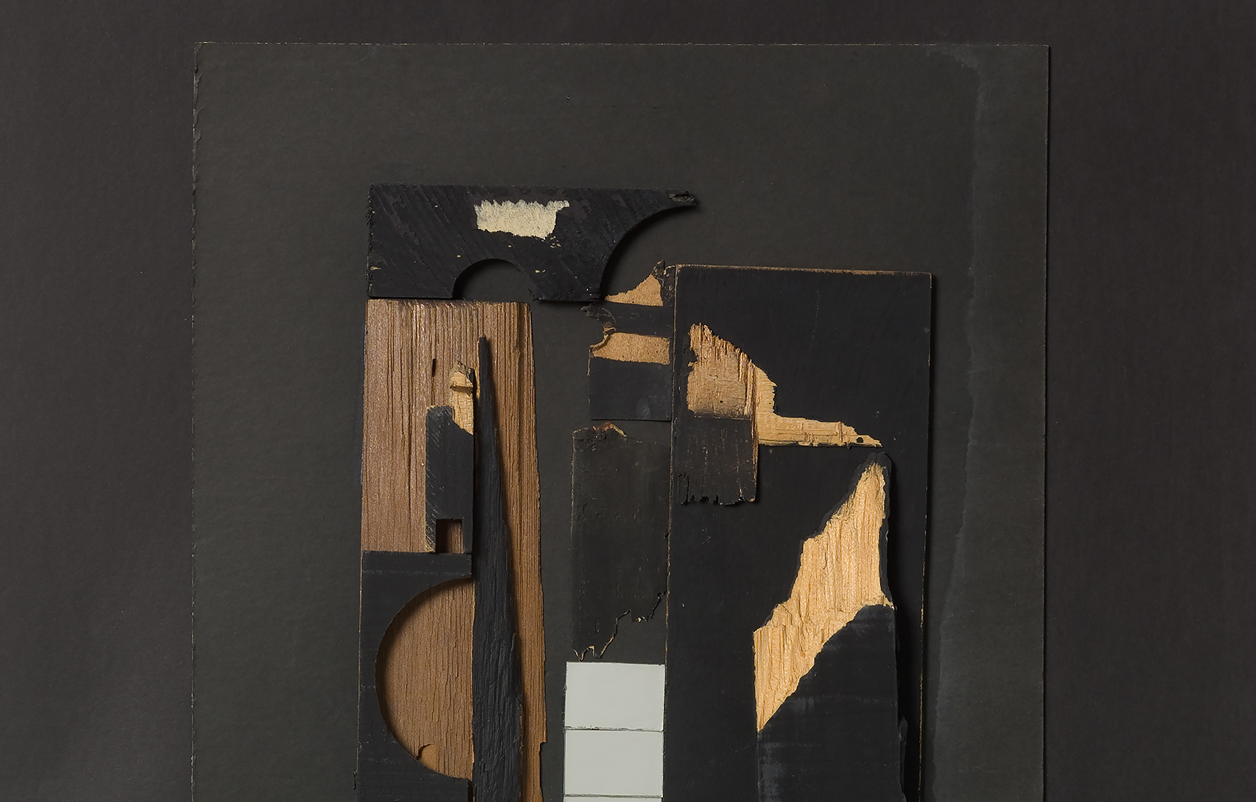 Detail view of Louise Nevelson's cardboard, mirror, and wood on board piece Untitled