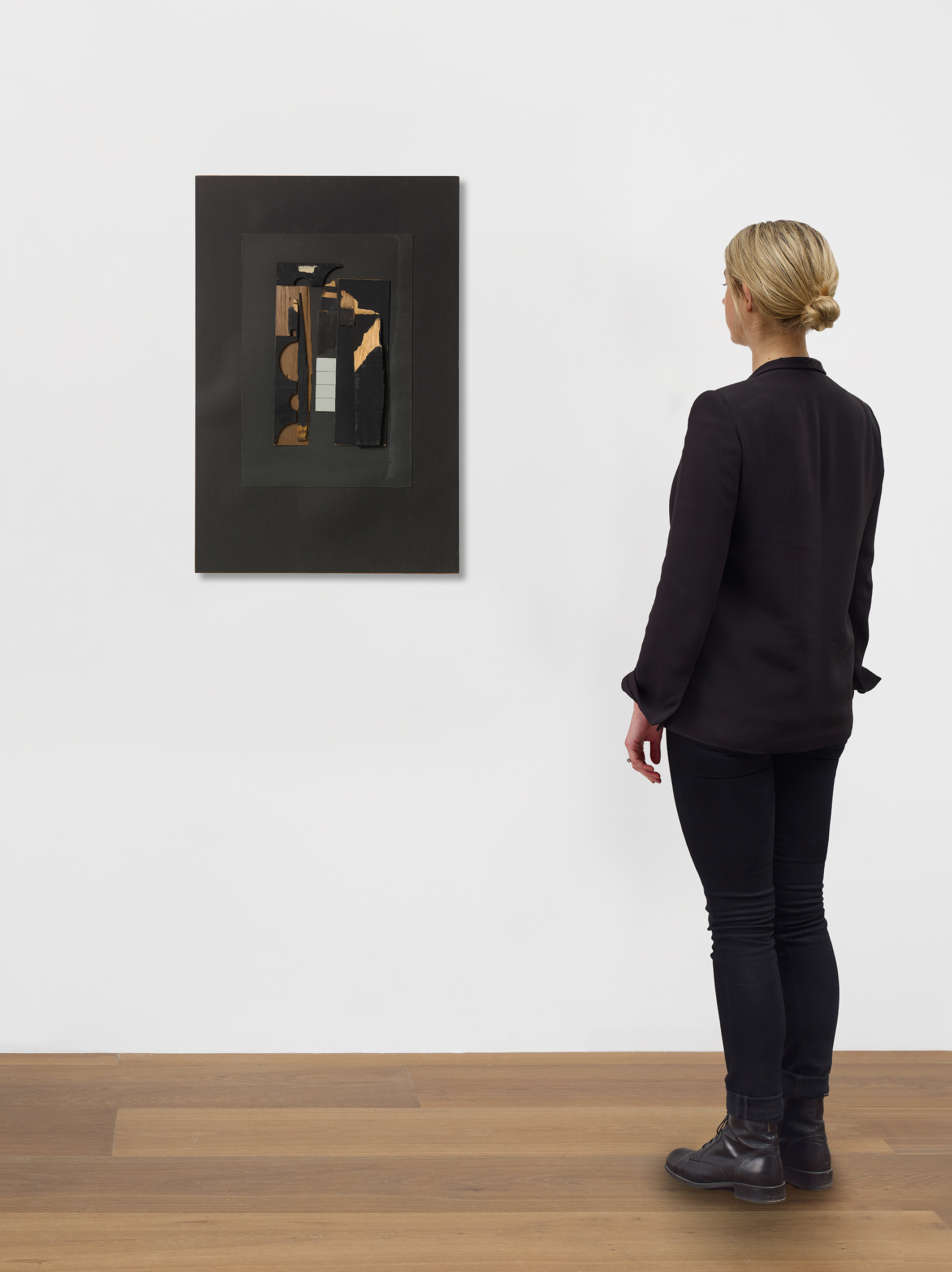 Scale view of Louise Nevelson's cardboard, mirror, and wood on board piece Untitled