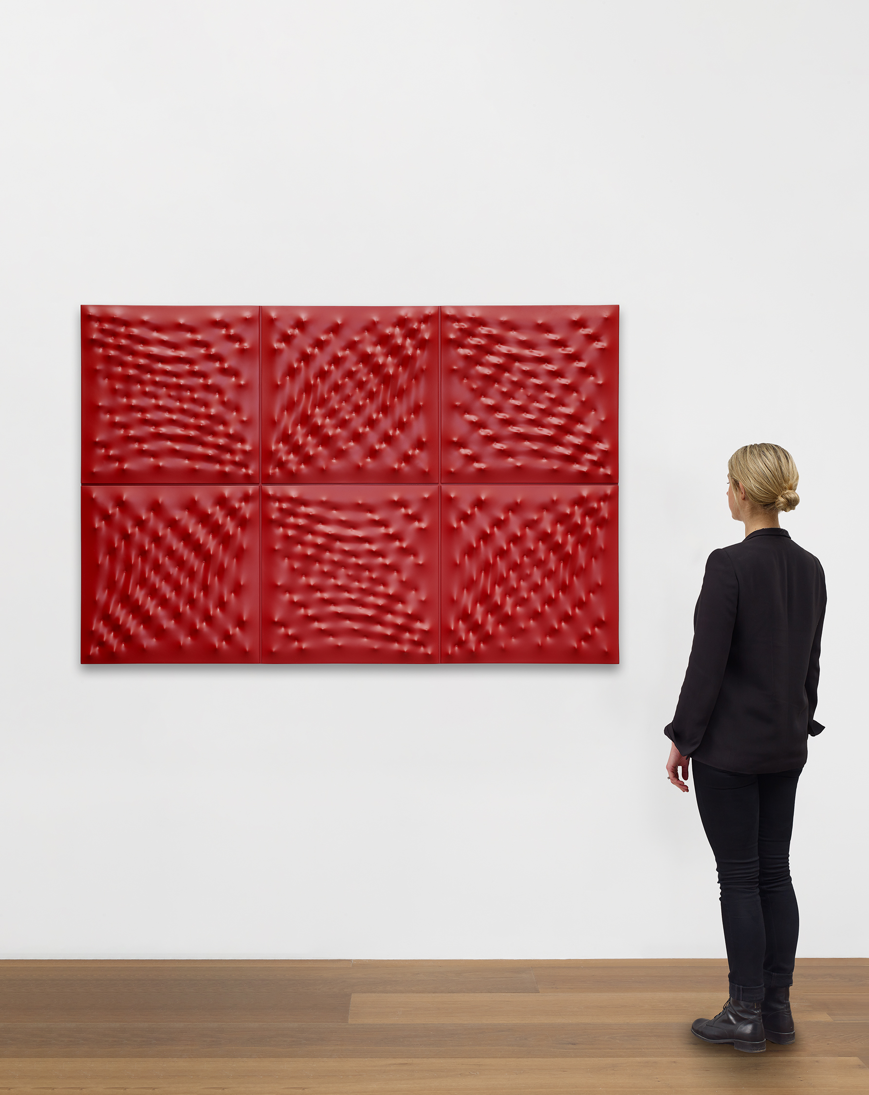 Scale view of Enrico Castellani's enamel on cast aluminum sculpture Superficie rossa