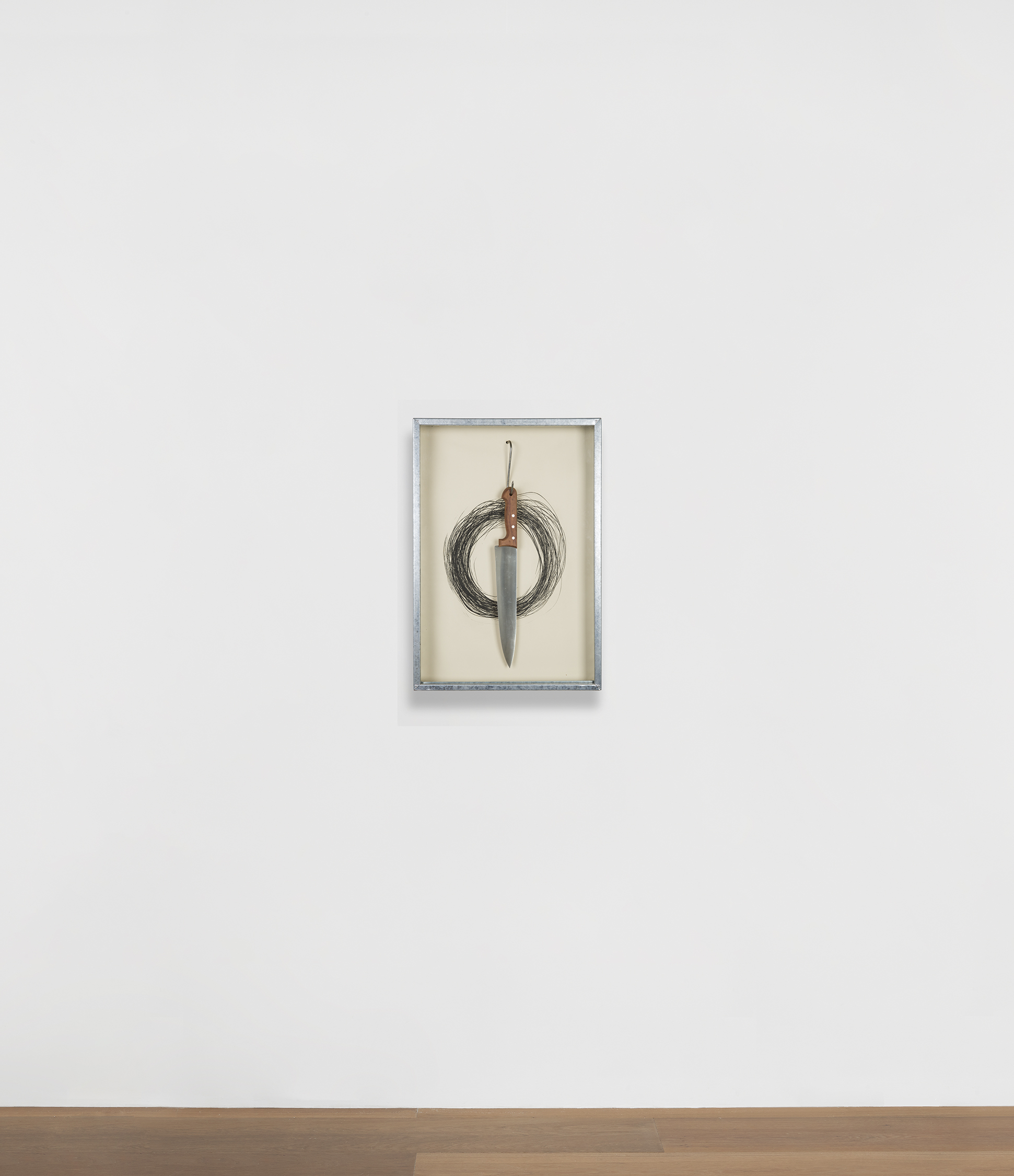 Installation view of Jannis Kounellis's work Untitled (Hanging Knife)