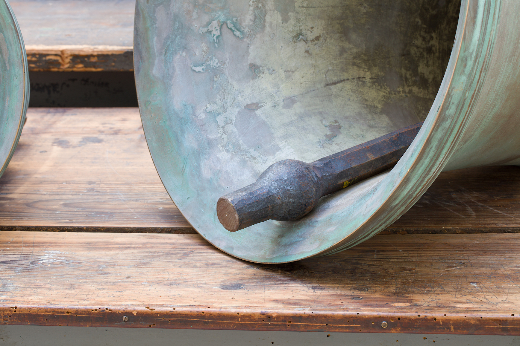 Detail view of Jannis Kounellis's Untitled wooden tables and bronze bells work