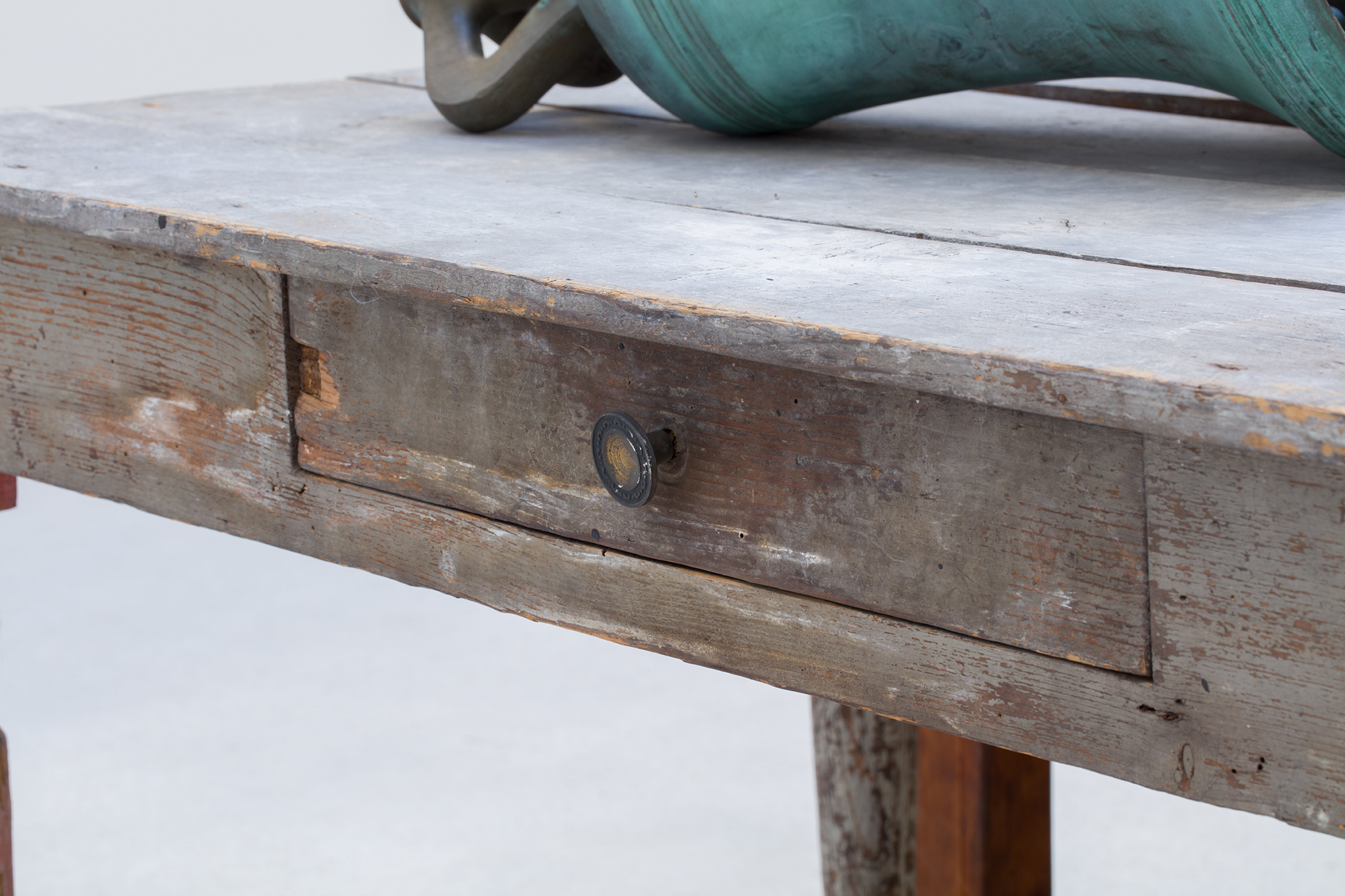 Detail view of Jannis Kounellis's Untitled wooden tables and bronze bells work