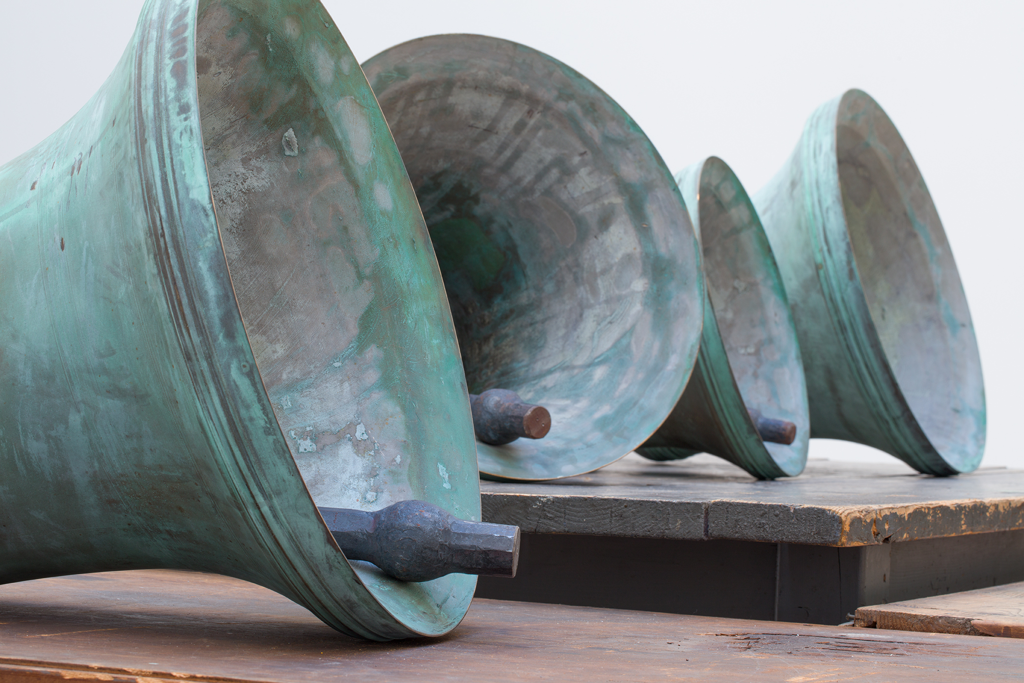 Detail view of Jannis Kounellis's Untitled wooden tables and bronze bells work