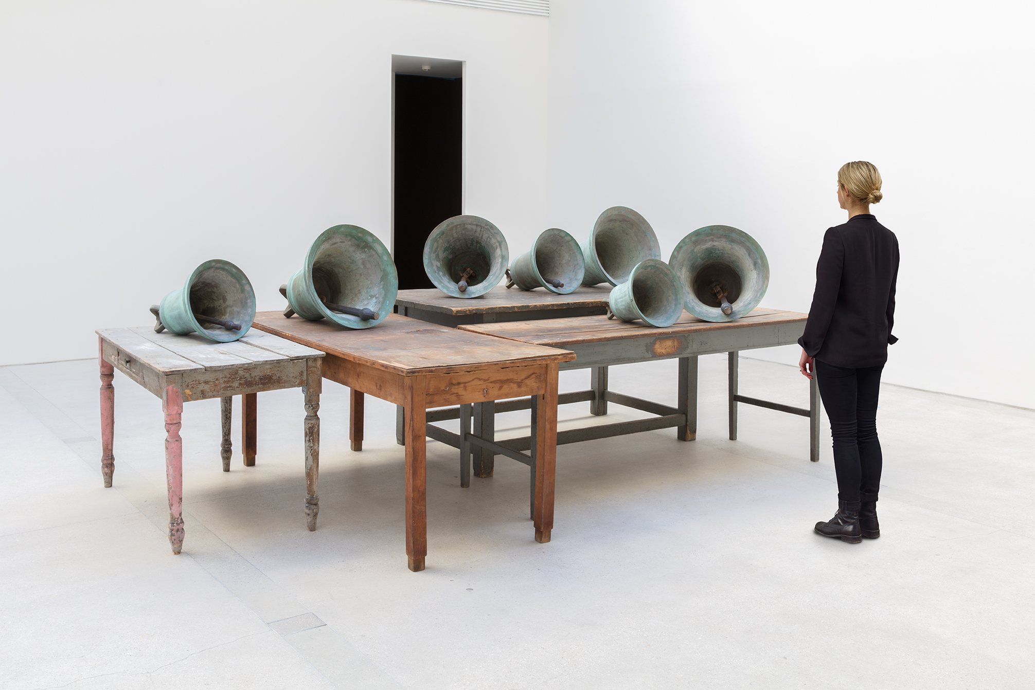 Scale view of Jannis Kounellis's Untitled wooden tables and bronze bells work