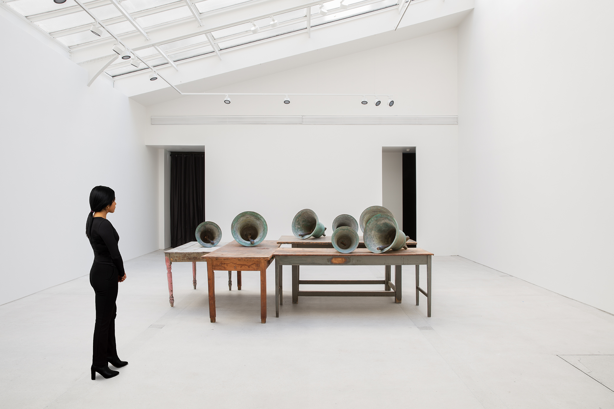 Scale view of Jannis Kounellis's Untitled wooden tables and bronze bells work